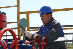 Андрей Щербаков, лучший оператор по исследованию скважин, измеряет давление с помощью ручного манометра